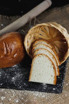 Slices of whole grain rye fresh bread on a dark background close up. Fresh home-baked sourdough bread