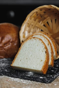 Slices of whole grain rye fresh bread on a dark background close up. Fresh home-baked sourdough bread