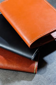 Black leather cardholder on a gray background. Handmade leather products.