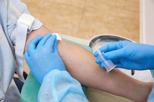 Nurse doing blood test from vein. Covid testing concept
