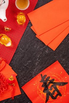 Design concept of Chinese lunar January new year - Festive accessories, red envelopes (ang pow, hong bao), top view, flat lay, overhead above. The word 'chun' means coming spring.