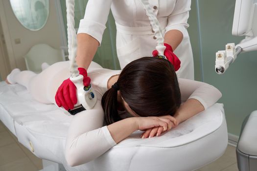Beautiful woman getting beauty therapy against cellulite with LPG machine. LPG massage for lifting body