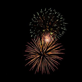 Colorful fireworks isolated on black sky background.