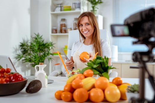 Attractive fitness girl keeping her daily blog and telling her followers how to be fit while eating healthy.