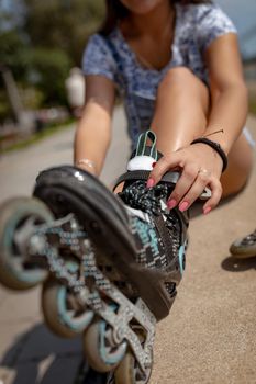 Close-up of a young woman preparing for roller skating.