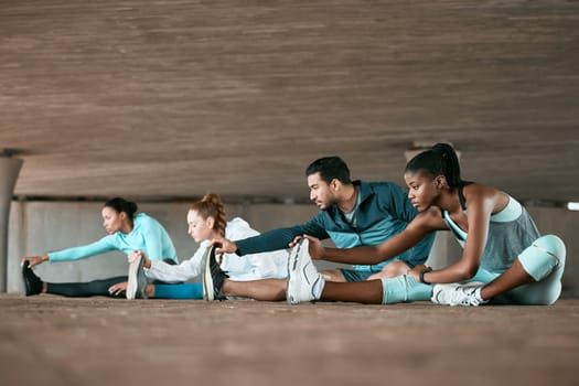 Group, exercise and people stretching as a fitness club for sports, health and wellness in an urban town together. Sport, commitment and friends training or team doing pilates workout in yoga.