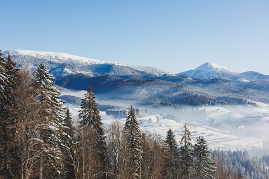 Winter landscape of snowy mountains with winter forest. Winter landscape