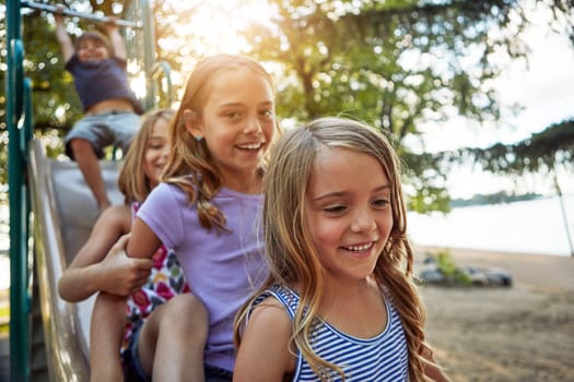 We will cherish these memories forever. siblings playing in a playground outdoors