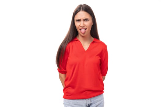 close-up portrait of a funny young european brunette lady in a red t-shirt with a grimace.