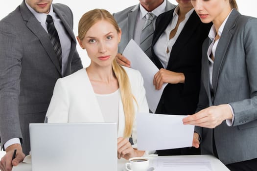 Female business leader talking to coworkers at meeting