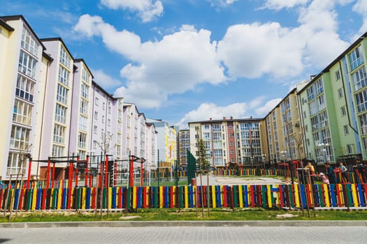 New residential high-rise buildings. Apartments with balconies in a new area. Modern residential buildings. Children's playground in the courtyard of a residential building.