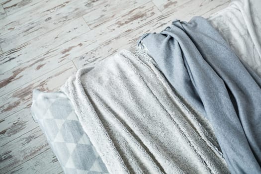 Gray warm blankets for the interior in the apartment lie on the bed