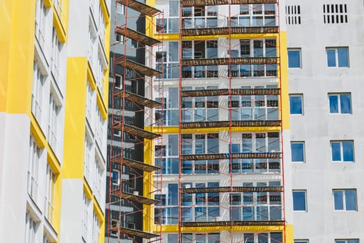 Detail in Modern residential flat apartment building exterior. Fragment of New luxury house and home complex. Part of City Real estate property and condo architecture. Copy space. Blue sky