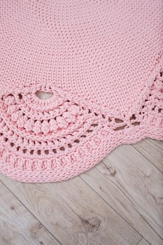 Handmade carpet knitted from natural threads, flooring, natural cotton. Pink handmade carpet. Interior solution for a house or apartment