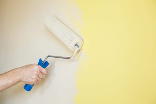 Professional wall painting, roller painting on interior walls. Renovation concept