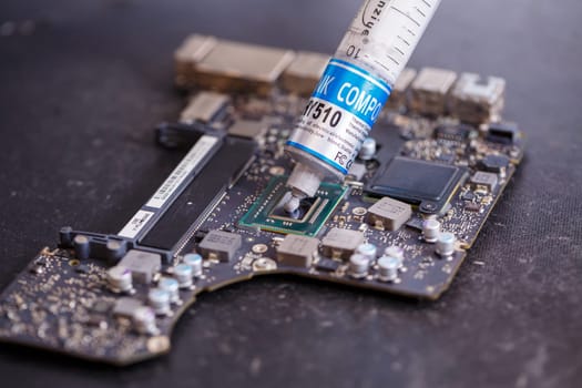 Professional computer and tablet repair shop or service. Close up of a computer board. Electronics concept. Detail from a laptop under repair