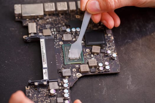 Professional computer and tablet repair shop or service. Close up of a computer board. Electronics concept. Detail from a laptop under repair