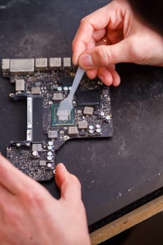 Professional computer and tablet repair shop or service. Close up of a computer board. Electronics concept. Detail from a laptop under repair