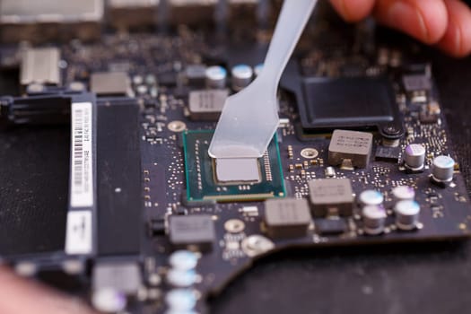 Professional computer and tablet repair shop or service. Close up of a computer board. Electronics concept. Detail from a laptop under repair