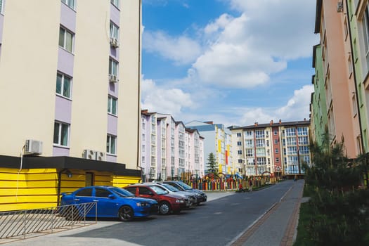 New-constructed unfinished multi-storey residential building. multi-storey residential house in brown and beige colors. Modern residential construction. Residential fund. Building on background of sky