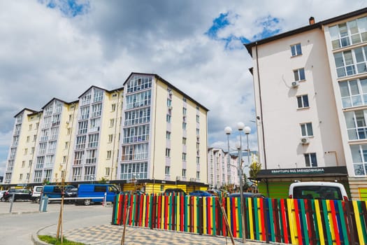 New-constructed unfinished multi-storey residential building. multi-storey residential house in brown and beige colors. Modern residential construction. Residential fund. Building on background of sky