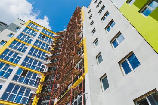 Detail in Modern residential flat apartment building exterior. Fragment of New luxury house and home complex. Part of City Real estate property and condo architecture. Copy space. Blue sky