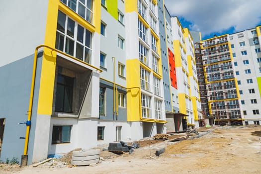 Detail in Modern residential flat apartment building exterior. Fragment of New luxury house and home complex. Part of City Real estate property and condo architecture. Copy space. Blue sky