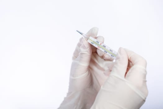diseased woman in protective medical surgical mask with a thermometer in his hand treated against the virus. Isolated on white background