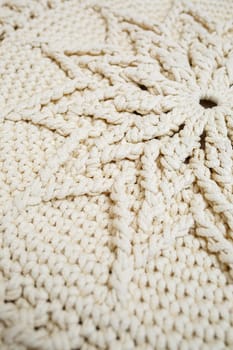 Handmade carpet knitted from natural threads, flooring, natural cotton. Beige handmade carpet. Knitted decorative item