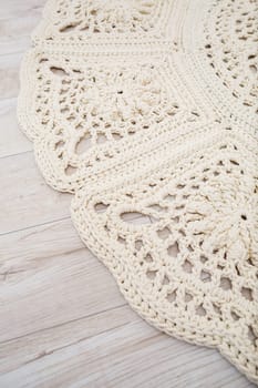 Handmade carpet knitted from natural threads, flooring, natural cotton. Beige handmade carpet. Knitted decorative item