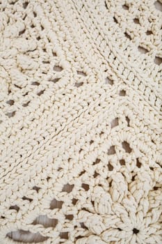 Handmade carpet knitted from natural threads, flooring, natural cotton. Beige handmade carpet. Knitted decorative item