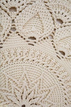 Handmade carpet knitted from natural threads, flooring, natural cotton. Beige handmade carpet. Knitted decorative item