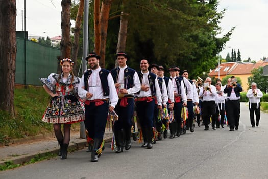 Brno - Bystrc, Czech Republic, 24 June, 2023. Traditional festivities of the feast of the feast in the Czech Republic. Food and drink festival. Girls and boys dancing in beautiful colourful traditional costumes. An old Czech custom of celebrating in villages. 