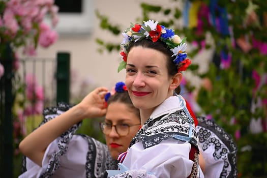 Brno - Bystrc, Czech Republic, 24 June, 2023. Traditional festivities of the feast of the feast in the Czech Republic. Food and drink festival. Girls and boys dancing in beautiful colourful traditional costumes. An old Czech custom of celebrating in villages. 