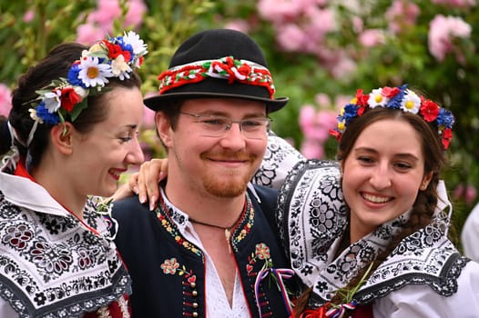 Brno - Bystrc, Czech Republic, 24 June, 2023. Traditional festivities of the feast of the feast in the Czech Republic. Food and drink festival. Girls and boys dancing in beautiful colourful traditional costumes. An old Czech custom of celebrating in villages. 