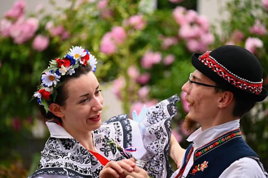 Brno - Bystrc, Czech Republic, 24 June, 2023. Traditional festivities of the feast of the feast in the Czech Republic. Food and drink festival. Girls and boys dancing in beautiful colourful traditional costumes. An old Czech custom of celebrating in villages. 