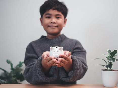 A boy holding piggy bank. Learning financial responsibility and projecting savings. savings concept. investment concept.