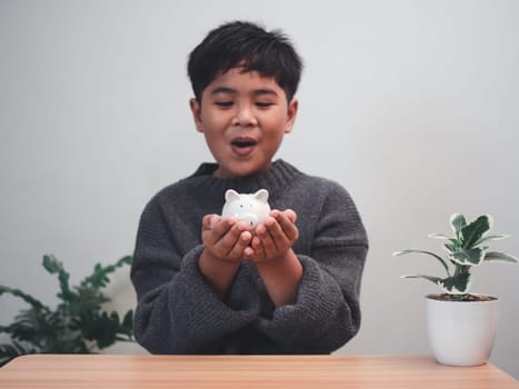 A boy holding piggy bank. Learning financial responsibility and projecting savings. savings concept. investment concept.