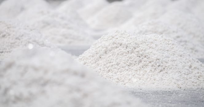 Sea salt farm. Pile of brine salt. Raw material of salt industrial. Sodium Chloride mineral. Evaporation and crystallization of sea water. White salt harvesting. Agriculture industry. Traditional farm