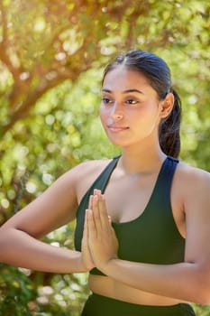 Yoga, praying hands and woman in nature for wellness, balance and peace on bokeh background. Pose, meditation and girl in countryside for mental health, zen and mindset, pilates and chakra workout.