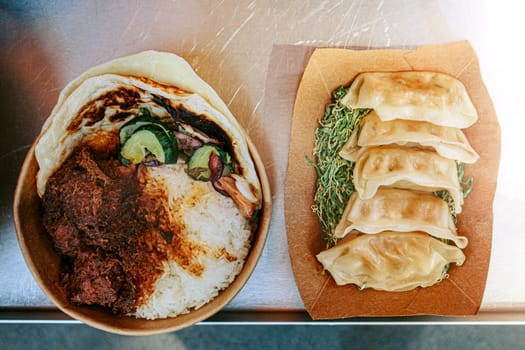 Asian street food market selling gyoza and rice dishes