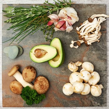 Now that looks delicious. High angle studio shot of mushrooms, avocado and herbs on a table