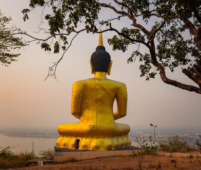 Golden Buddha overlooking Pakse at sunset. Wat Phousalao. Laos