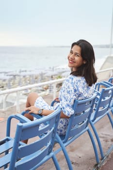 Beautiful smiling young mixed race woman at the Promenade des Anglais in Nice, France