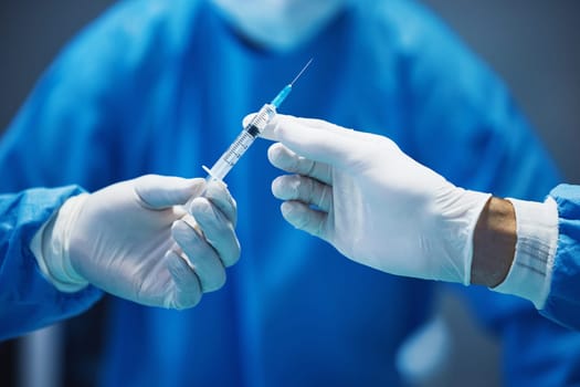 Surgery, nurse hands doctor syringe with medicine and surgical procedure, closeup and healthcare in hospital. Health insurance, needle and injection with drugs and surgeon people in operating room.