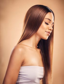 Beauty, hair and face profile of woman in studio for wellness, keratin treatment and haircare aesthetic. Salon, hairdresser and happy female person on brown background for growth, shine and texture.
