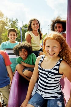The park is our favourite summer hangout. Portrait of a group of diverse and happy kids hanging out together outside