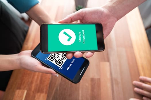 Seamless cashless payments with barcode scanning on smartphone application. Utilizing QR code technology, secure and fast transactions for modern shopping lifestyle with mobile banking app. Jubilant
