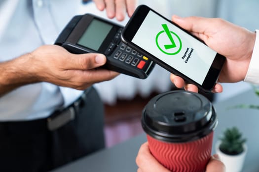 Hand holding smartphone with NFC QR code device, scanning contactless payment code for fast digital transaction. Online banking app on mobile phone for modern lifestyle payment technology. fervent