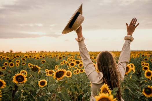 Woman in the sunflowers field. Summer time. Young beautiful woman standing in sunflower field.